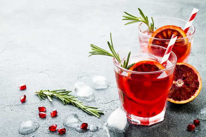 twee rode cocktails met citrus en tijm